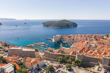 Aerial drone shot of Otok Lokrum in Dubrovnik in with port view in Croatia summer morning