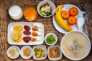 Breakfast set, boiled rice set with milk, orange juice, orange fruit and banana
