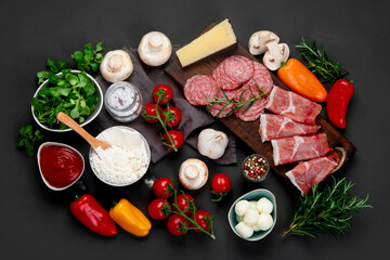 Italian pizza preparation. Variety of traditional cooking ingredients.