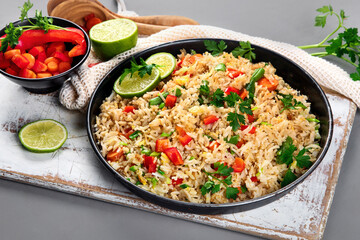 Vegan fried rice with pepper, carrot and green beans and greens