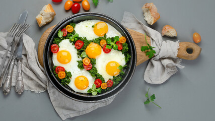Fried eggs in frying pan for breakfast. Grey background