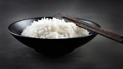 Hot boiled rice in japanese bowl on black background