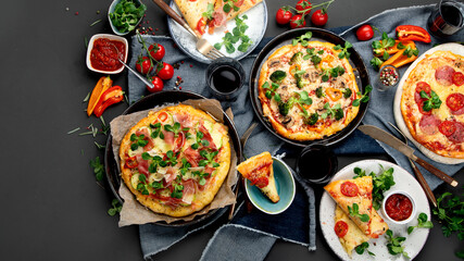 Delicious fresh pizzas variety with different souces and vegetables. Homemade food concept.