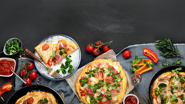 Delicious fresh pizzas variety with different souces and vegetables. Homemade food concept.