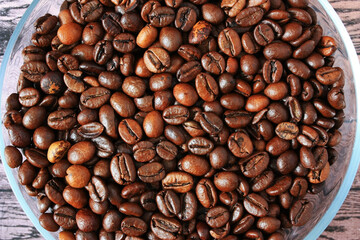 Brown coffee beans on a plate