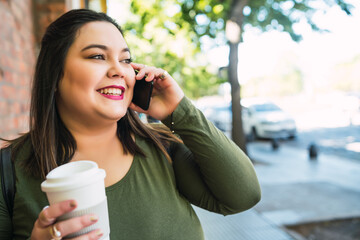 Young plus size woman talking on the phone.