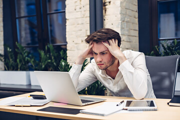 Concentrated businessman working on laptop