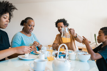 Family having breakfast together at home.