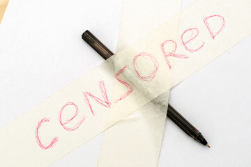 the fountain pen is taped to the paper with the inscription censored concept of freedom of speech