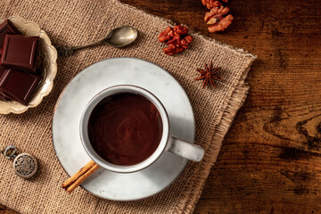 Hot chocolate, overhead flat lay shot with copy space on a dark rustic wooden background