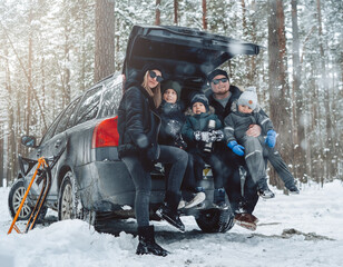 Weekends and relaxation. Journey of a caucasian family with car they enjoy and have fun in forest in cold season.