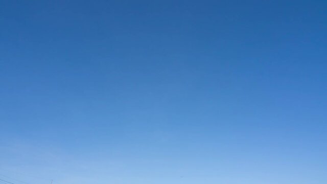 timelapse of clear sky with tiny fluffy white cumulus clouds rising in the coner of the screen.
