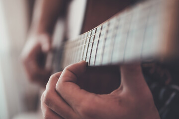 Fototapeta premium close up of a person playing guitar