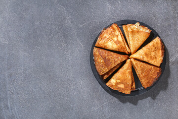 Thin pancakes from Russian cuisine. Russian blini, crepes on a gray background. Shrovetide holiday. Pancake week. Top view.