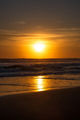 Obraz premium Sunset and beach. Seascape background. Bright sunlight. Sun at horizon line. Scenic view. Sunset golden hour. Sunlight reflection in water. Magnificent scenery. Copy space. Bali
