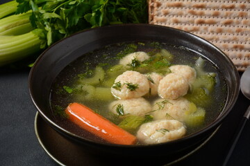 Chicken Matzo ball soup with carrots in the bowl. Jewish traditional Passover holiday food