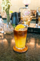orange and lemon juice soda topped with black coffee