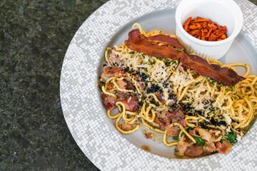 stir-fried spaghetti with garlic, olive oil, parsley, Parmigiano-Reggiano cheese tossed and bacon