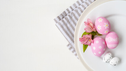 Healthy nutrition. Protein diet. Culinary art. Creative food catering. Pink painted organic quail chicken Easter eggs flowers served in plate isolated on white conceptual copy space background.