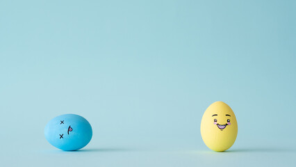 Stress management. Problem solution. Challenge overcome motivation. Happy yellow color egg winner with smiley face enjoying victory over blue enemy isolated on light conceptual copy space background.