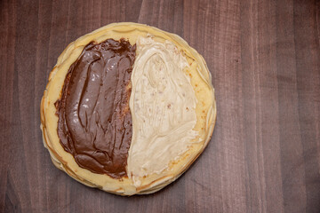 Pancakes with chocolate cream. Homemade. Pancakes for breakfast and carnival. Pancakes on the plate. Food background.