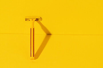 Fototapeta na wymiar Disposable razors on yellow background, studio shot