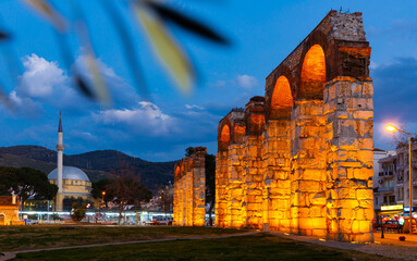 View of illuminated ruins of ancient Byzantine aqueduct in Selcuk at twilight, Turkey