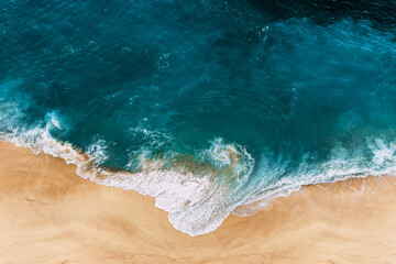 Wild beach with a beautiful clear ocean. Ocean from a bird's eye view. Top view of the tropical...