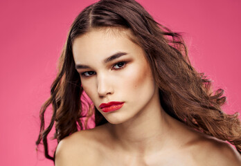 Pink background female portrait bared shoulders red lips