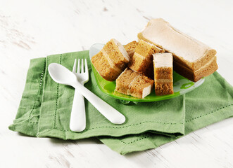 Delicate apple marshmallow sliced in a plate, a napkin and a spoon with a fork on a white background, Vegan food