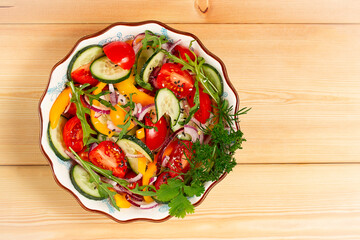 Fresh vegetable salad, on a wooden table, top view, horizontal, no people,