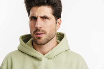 Thinking handsome man in sportswear posing and looking at camera