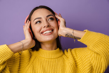Happy beautiful girl listening music with wireless headphones
