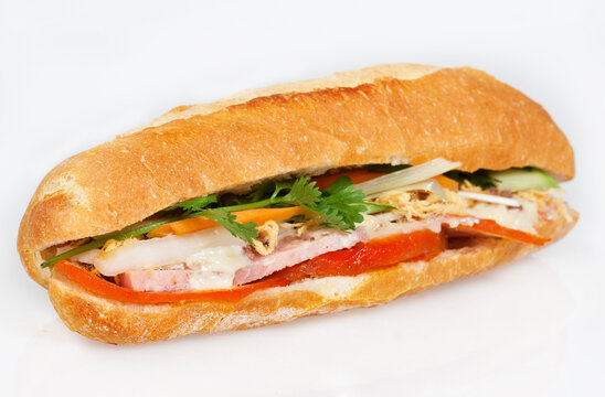 Famous Vietnamese food is banh mi thit, popular street food from bread stuffed with raw material: pork, ham, pate, egg and fresh herbs as scallions, coriander, carrot, cucumber, chilli.