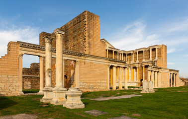 Fototapeta na wymiar View of notable ruins of Roman bath-gymnasium complex in ancient Sardis city in sunny winter day, Turkey