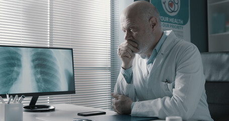 Doctor analyzing an x-ray image on the computer screen