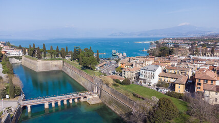 Fototapeta na wymiar Aerial view of the ancient fortified town of Peschiera dal Garda, protected by mighty Renaissance walls and canals that surround it.