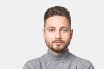 Fototapeta premium Closeup portrait of handsome serious young man, smiling joyful cheerful men isolated studio shot.