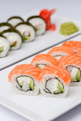 Maki Sushi - Roll made of smoked salmon and cream cheese. Traditional Japanese cuisine concept, over white background.