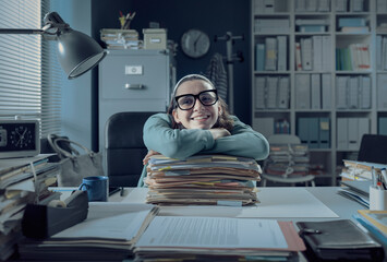 Inefficient office worker leaning on a pile of paperwork