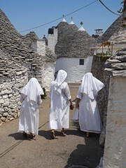 Historic street with Trullo (Trulli) stone houses with conical roof, popular tourist travel...