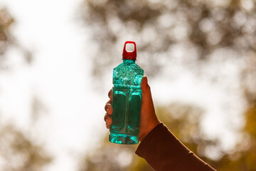 Clear blue green water bottle, the lid is red with a hole in the center for portability, natural...