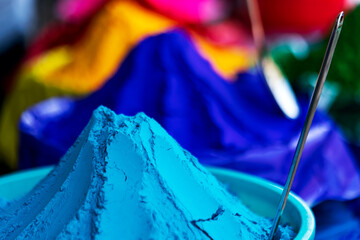 Holi Dye Powders Selling On A Shop. Vendor selling various colors of holi powder, gulal, abir on a market. Concept for Holi preparation. Stock image for background, graphic resources, flyer, poster, c