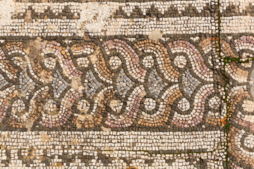 Closeup of patterns of ancient stone mosaic for facing floor and walls in ruined Roman bath gymnasium complex in Sardis, Salihli, Turkey