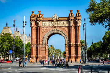 Fototapeta na wymiar Barcelona, Spain - July 25, 2019: Tourists and locals walking through the Triumphal Arch of Barcelona in Spain