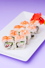 Shrimp sushi close up, Japanese cuisine. Asian cuisine concept. Served on a white plate over purple background