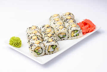 Sushi large set served on a white plate over white background. Traditional Asian Japanese cuisine concept.