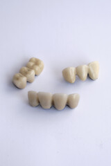 Fototapeta na wymiar Dental braces and dentures on a white background
