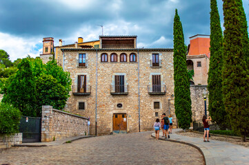 Girona, Spain - July 28, 2019: Tourists walking in the streets of Girona in Catalonia, Spain
