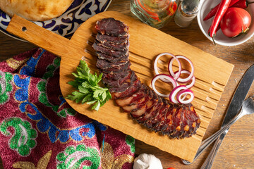 Homemade dried horse meat sausage with coriander and red onion